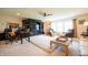 This spacious living room features hardwood floors, a fan, and great natural light at 4420 Hickory Ridge Blvd, Greenwood, IN 46143