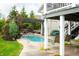 Inviting backyard pool with hot tub, pergola, and swing for relaxing outdoors at 4420 Hickory Ridge Blvd, Greenwood, IN 46143