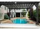 Pool view features a dark pergola and swing with the house in the background at 4420 Hickory Ridge Blvd, Greenwood, IN 46143