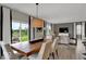 Bright dining area with modern table, chairs, open to living room with natural light at 4460 Laughter Ln, Indianapolis, IN 46235