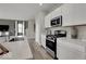 Well-lit kitchen with stainless steel appliances, plenty of countertop space and white cabinetry at 4460 Laughter Ln, Indianapolis, IN 46235