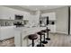 Bright kitchen boasts white cabinetry, stainless steel appliances, and a large island with seating at 4460 Laughter Ln, Indianapolis, IN 46235