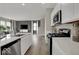 Bright open concept kitchen with stainless steel appliances and view of the living room and dining area at 4460 Laughter Ln, Indianapolis, IN 46235