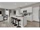 Modern kitchen showcasing an island with bar stools, white cabinets, and stainless steel appliances at 4460 Laughter Ln, Indianapolis, IN 46235