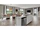 Open concept kitchen featuring stainless steel appliances, white cabinetry, and dining area at 4460 Laughter Ln, Indianapolis, IN 46235