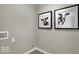 Functional laundry room has a vent, outlet and two funny cow pictures on the wall at 4460 Laughter Ln, Indianapolis, IN 46235