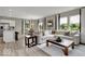 Open-concept living room featuring plush sectional, modern decor, and seamless kitchen integration at 4460 Laughter Ln, Indianapolis, IN 46235