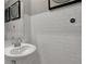 Chic powder room with pedestal sink, framed mirrors, and white subway tile backsplash at 4460 Laughter Ln, Indianapolis, IN 46235