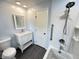 Bright bathroom featuring vanity with storage, and a shower-tub combo at 5130 Navajo Ct, Columbus, IN 47203