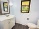 Cozy bathroom featuring a large mirror, white vanity, modern lighting, and tiled floors at 5130 Navajo Ct, Columbus, IN 47203