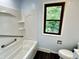 Bathroom with a combined shower and tub showcasing an outdoor view at 5130 Navajo Ct, Columbus, IN 47203