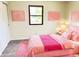 Pink bedroom with decor, carpeted floors, and natural light from the window at 5130 Navajo Ct, Columbus, IN 47203