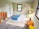Cheerful ' bedroom with colorful decor, carpeted floors, and window at 5130 Navajo Ct, Columbus, IN 47203