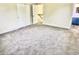 Spacious bedroom with gray carpet and view to landing at top of stairs at 5130 Navajo Ct, Columbus, IN 47203