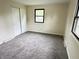 Empty bedroom with neutral walls, carpeted floor, and natural light from the window at 5130 Navajo Ct, Columbus, IN 47203