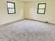 Empty bedroom with two windows, neutral walls, and carpeted floor at 5130 Navajo Ct, Columbus, IN 47203