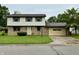 Charming two-story home with brick and siding, a well-maintained lawn, and an attached one-car garage at 5130 Navajo Ct, Columbus, IN 47203