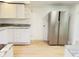 Well lit kitchen with white cabinets, modern stainless steel refrigerator, and granite countertops at 5130 Navajo Ct, Columbus, IN 47203