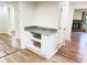 Eat-in kitchen features white cabinets, granite countertops, and built-in shelves at 5130 Navajo Ct, Columbus, IN 47203