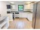 Bright kitchen featuring white cabinets, granite countertops, and stainless steel appliances at 5130 Navajo Ct, Columbus, IN 47203