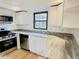 Close-up of kitchen showcasing granite countertops, stainless steel appliances, and ample storage at 5130 Navajo Ct, Columbus, IN 47203