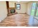 Spacious living room featuring a brick fireplace, built-in shelves, and sliding glass doors to the back patio at 5130 Navajo Ct, Columbus, IN 47203