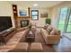 Cozy staged living room with brick fireplace, comfortable seating, and access to an enclosed porch at 5130 Navajo Ct, Columbus, IN 47203