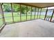 Enclosed screened-in porch offering an outdoor living space with views of the backyard at 5130 Navajo Ct, Columbus, IN 47203