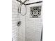 Elegant walk-in shower featuring white subway tiles and a decorative inset at 5130 Navajo Ct, Columbus, IN 47203