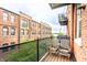 Relaxing balcony with seating, offering views of the surrounding brick buildings at 55 S Harding St # 308, Indianapolis, IN 46222