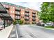 Charming brick apartment building featuring balconies, designated parking and lush green landscaping at 55 S Harding St # 308, Indianapolis, IN 46222