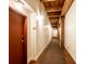 Hallway with neutral walls, beamed ceilings, carpet and well-placed lighting, creating a clean and inviting atmosphere at 55 S Harding St # 308, Indianapolis, IN 46222