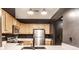 Modern kitchen with stainless steel appliances, light wood cabinets, and a sink with a sleek faucet at 55 S Harding St # 308, Indianapolis, IN 46222