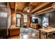 Inviting living area with wooden floors, exposed brick, comfortable seating, and a TV at 55 S Harding St # 308, Indianapolis, IN 46222