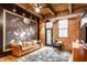 Cozy living room with a vintage-style sofa, brick walls, and wooden ceiling beams at 55 S Harding St # 308, Indianapolis, IN 46222