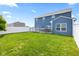 Spacious fenced backyard featuring a well-maintained lawn and large deck with privacy fence, ideal for gatherings at 5848 Sheffield Ln, Whitestown, IN 46075