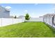 Fenced backyard with a green lawn and young tree. Perfect for and pets at 5848 Sheffield Ln, Whitestown, IN 46075