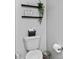 Well-organized bathroom with decorative shelves, toilet paper holder, and playful wall art at 5848 Sheffield Ln, Whitestown, IN 46075