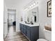 Bathroom with dual vanity, modern fixtures, and blue cabinet at 5848 Sheffield Ln, Whitestown, IN 46075