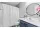 Charming bathroom with a round mirror, modern vanity, and shower-tub combination at 5848 Sheffield Ln, Whitestown, IN 46075