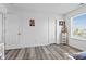 Bright bedroom featuring wood-look floors, a large window, and ample closet space at 5848 Sheffield Ln, Whitestown, IN 46075