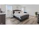 Bright bedroom with a luxurious bed, stylish side tables, and natural light from multiple windows at 5848 Sheffield Ln, Whitestown, IN 46075