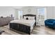 Modern bedroom showcasing a gray bed, white linens, and natural light at 5848 Sheffield Ln, Whitestown, IN 46075