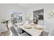 Dining area with a marble top table, six upholstered chairs, and natural light from a sliding glass door at 5848 Sheffield Ln, Whitestown, IN 46075