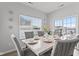 Bright dining room with a modern table, comfortable seating, large windows, and a sliding glass door at 5848 Sheffield Ln, Whitestown, IN 46075