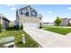 Exterior view showcasing the long concrete driveway and attached two-car garage at 5848 Sheffield Ln, Whitestown, IN 46075
