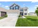 Beautiful two-story home with brick and siding exterior and well-manicured front lawn at 5848 Sheffield Ln, Whitestown, IN 46075