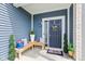 Welcoming front porch features wood benches, stylish pillows, and charming floral accents at 5848 Sheffield Ln, Whitestown, IN 46075