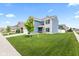 Landscaped front yard with lush green grass surrounding a modern two-story home at 5848 Sheffield Ln, Whitestown, IN 46075
