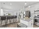 Modern kitchen featuring a center island with bar seating, stainless steel appliances, and an open floorplan at 5848 Sheffield Ln, Whitestown, IN 46075